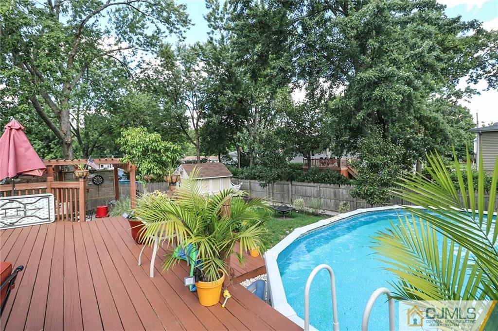 66 Harmon Road Edison, NJ 08837 - Photo 22 of 25 a view of a swimming pool with a patio