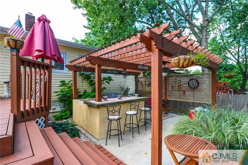 66 Harmon Road Edison, NJ 08837 - Photo 23 of 25 a view of patio with a table and chairs and potted plants
