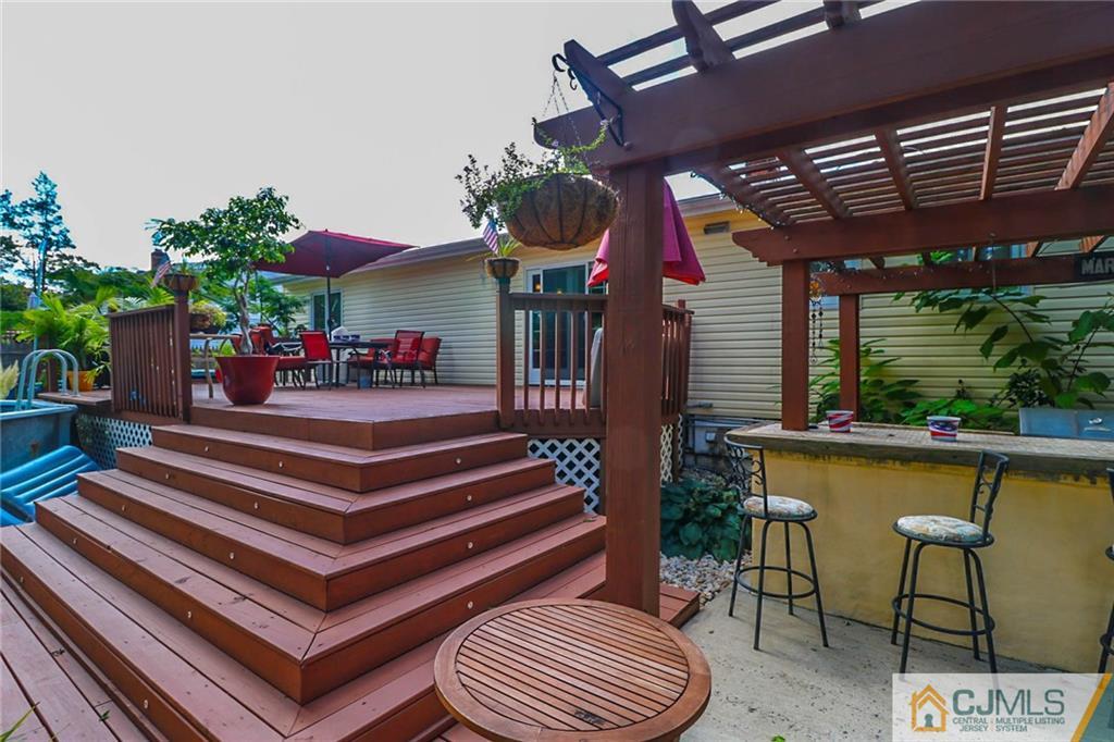 66 Harmon Road Edison, NJ 08837 - Photo 25 of 25 a view of a chairs and table in patio with potted plants