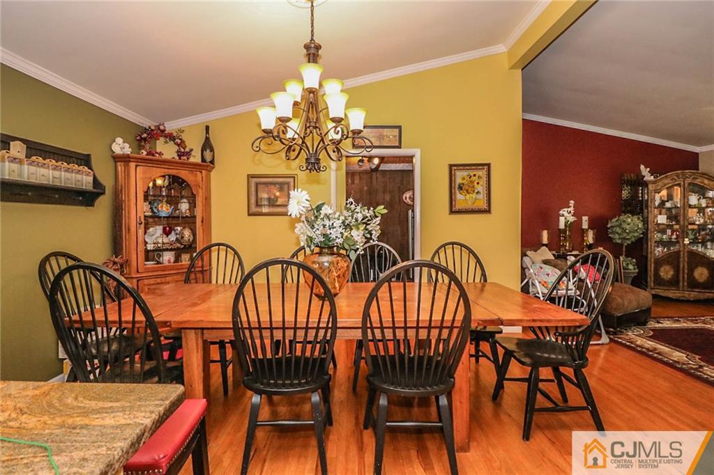66 Harmon Road Edison, NJ 08837 - Photo 10 of 25 a view of a dining room with furniture wooden floor and chandelier
