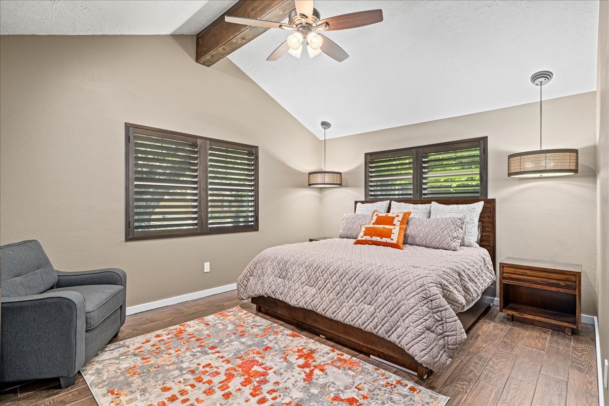 1502 Reimer Street Brenham, TX 77833 - Photo 15 of 30 a bedroom with a bed and wooden floor