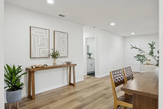 a view of a dining room with furniture and wooden floor