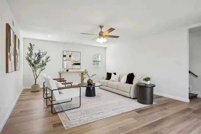 a living room with furniture and wooden floor