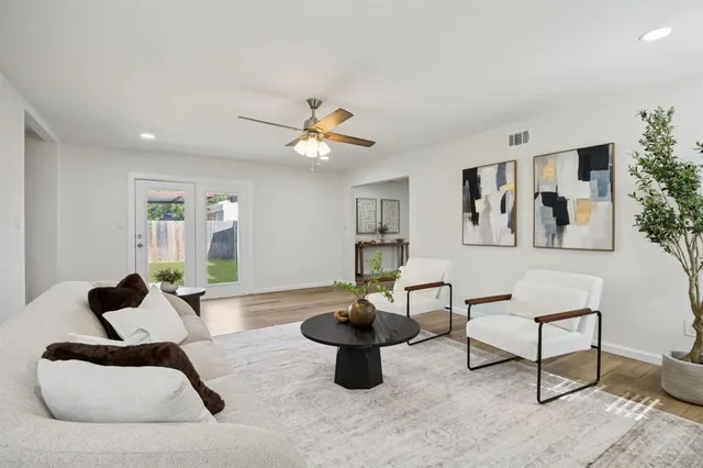 a living room with furniture a rug and a window