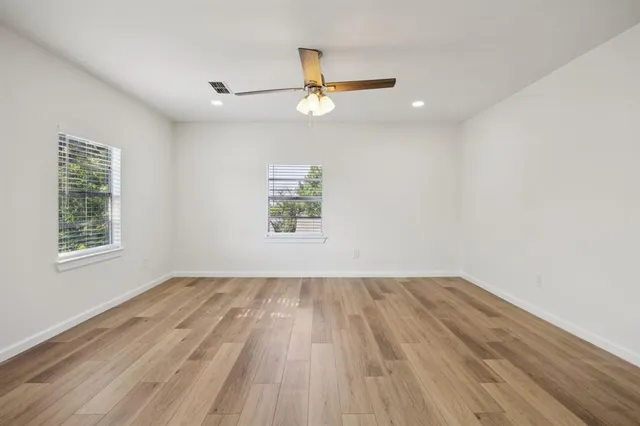 wooden floor in an empty room with a window