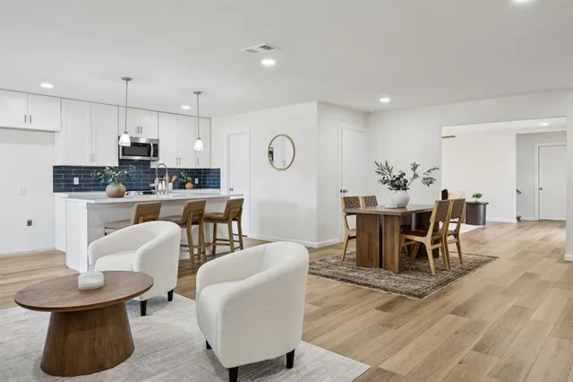 a dining room with furniture and wooden floor