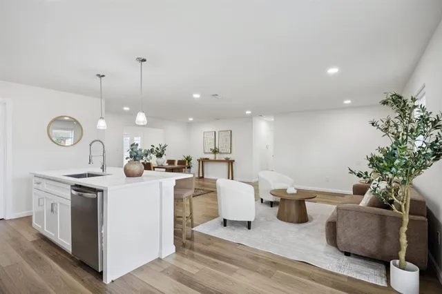 a view of kitchen with appliances and living room