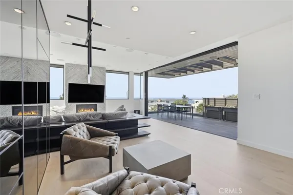 a living room with furniture a flat screen tv and a large window