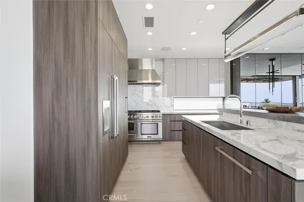 a kitchen with stainless steel appliances granite countertop a sink stove and cabinets