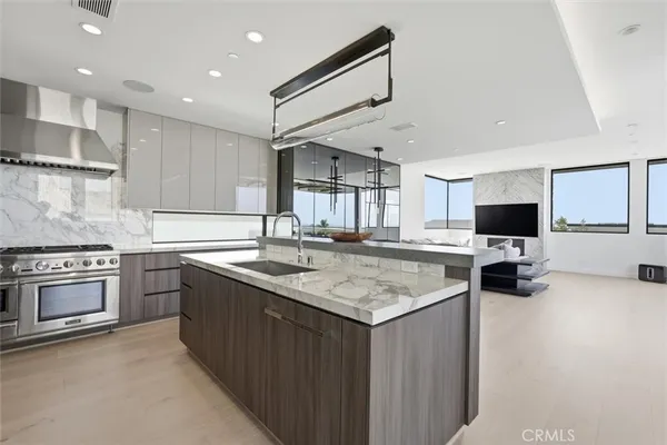 a kitchen with stainless steel appliances granite countertop a sink and microwave