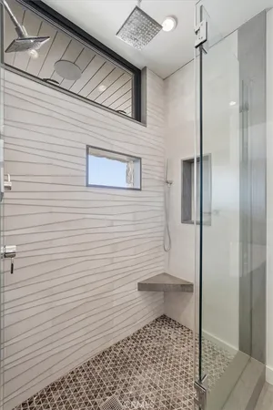 a bathroom with a sink a toilet a shower and a mirror