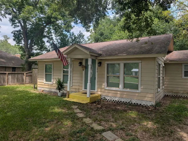 a front view of a house with a garden and porch