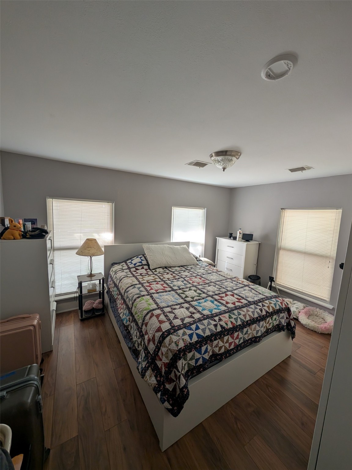 1910 Reese Street Liberty, TX 77575 - Photo 4 of 7 a bedroom with a bed and wooden floor