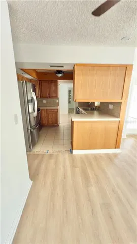 a bathroom with a granite countertop sink a toilet and a mirror