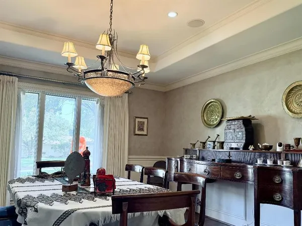 a living room with dining table and a large window