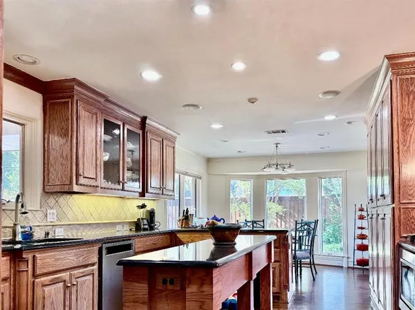 a large kitchen with lots of counter space a sink and furniture