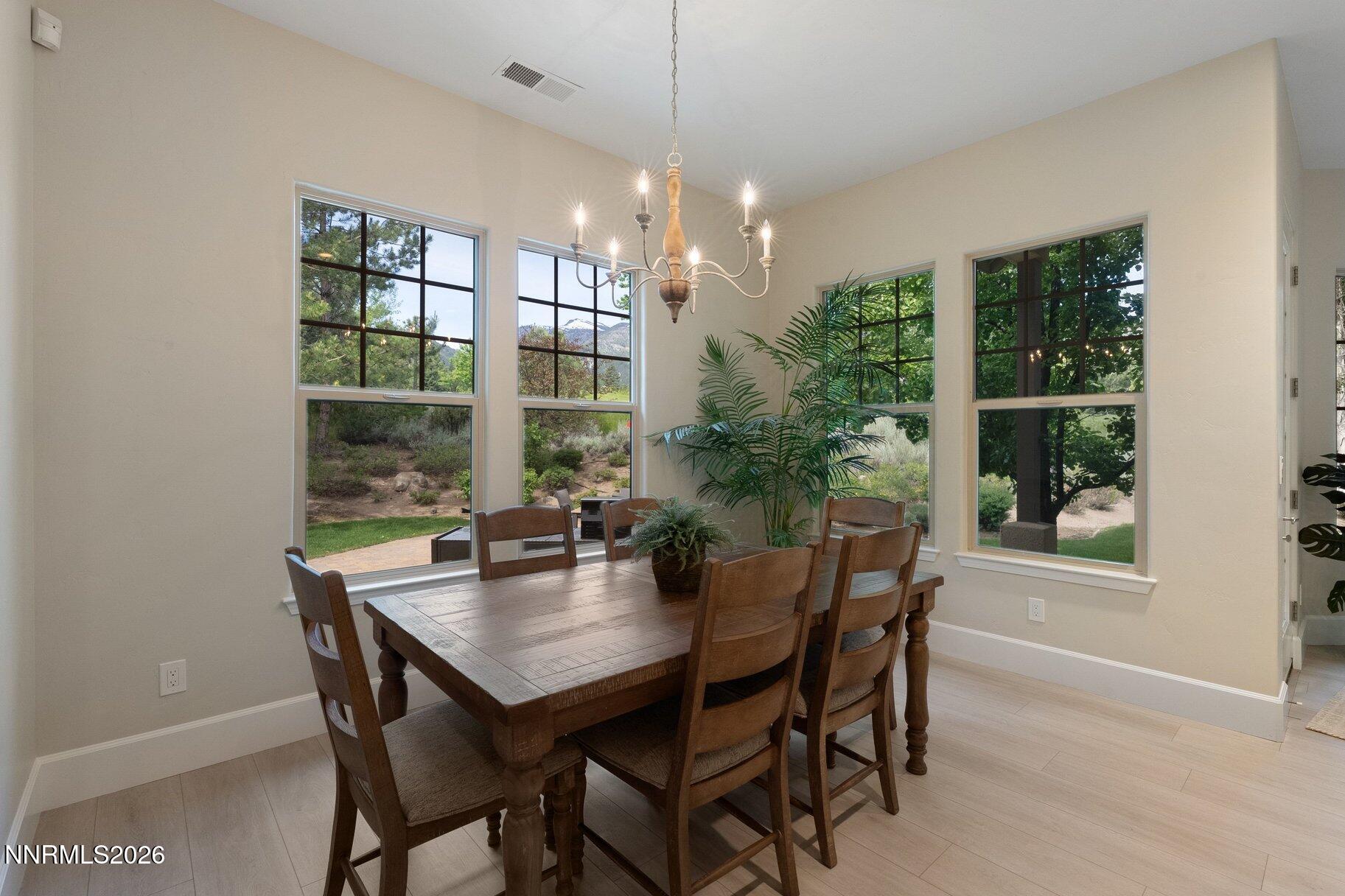 16925 Rue Du Parc Reno, NV 89511 - Photo 11 of 34 a dining room with furniture window and wooden floor