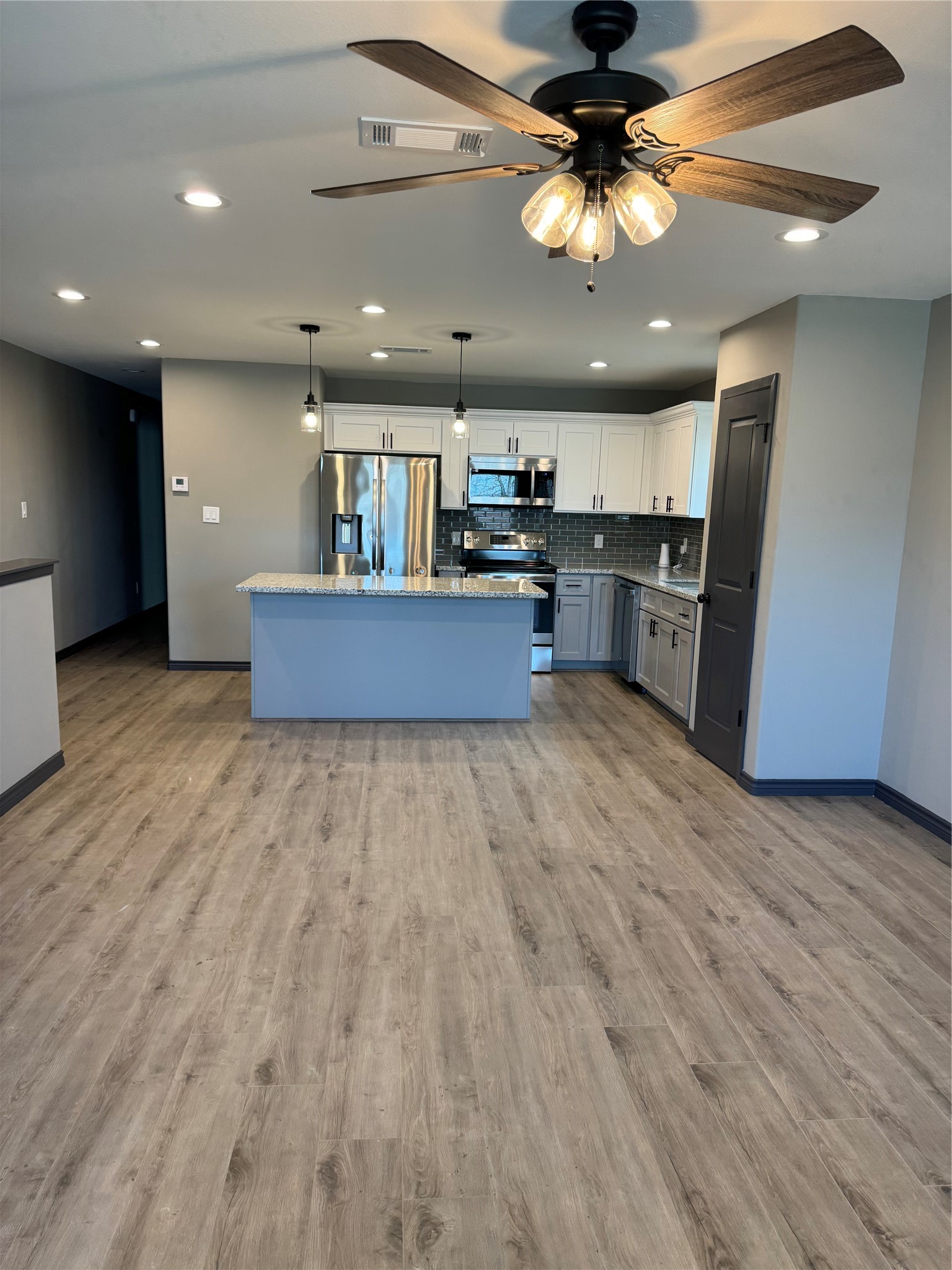 7906 Sexton Street Houston, TX 77028 - Photo 20 of 20 a kitchen with stainless steel appliances granite countertop a refrigerator a sink dishwasher a stove and a dining table with wooden floor