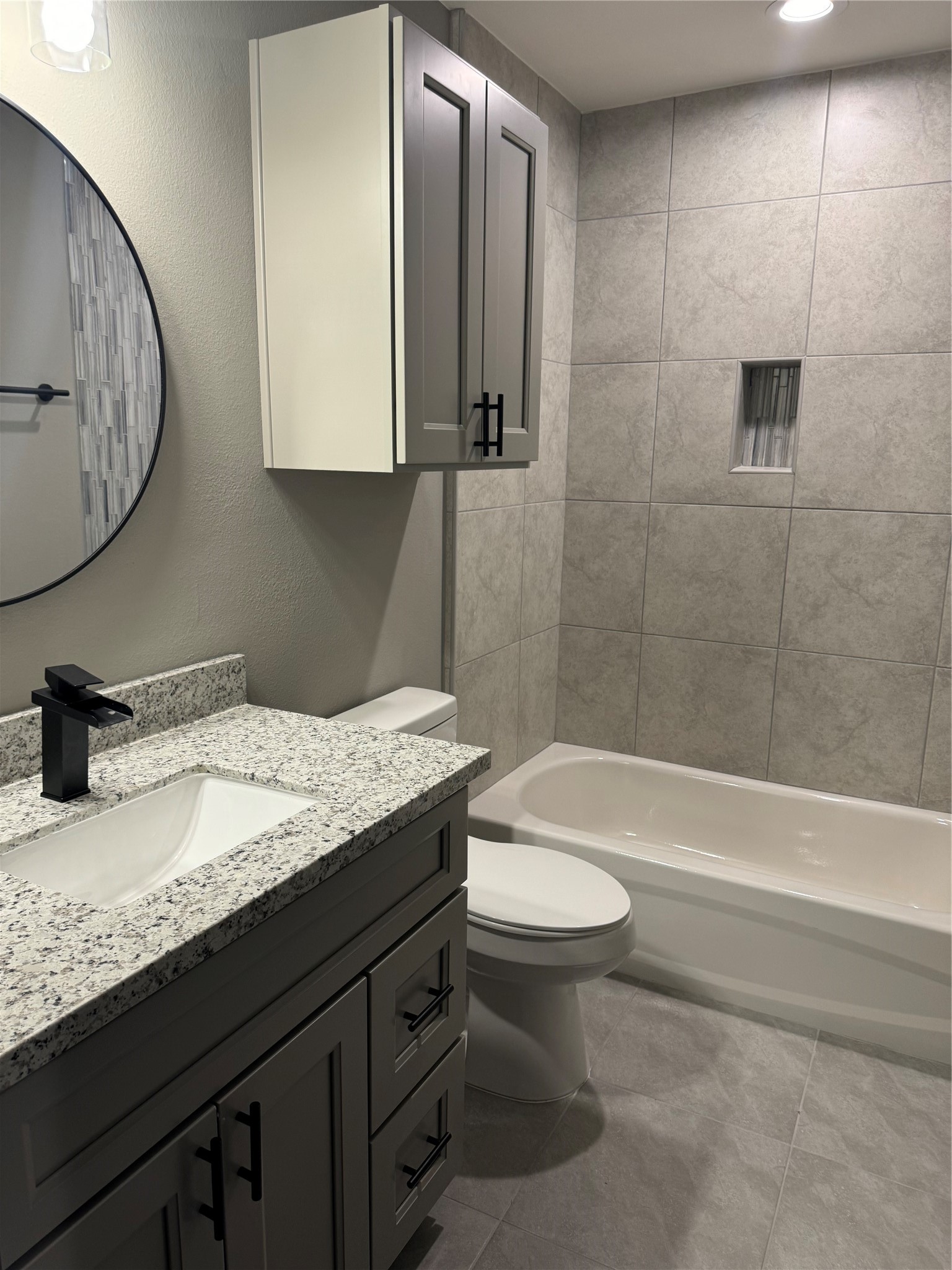 7906 Sexton Street Houston, TX 77028 - Photo 13 of 20 a bathroom with a granite countertop sink a toilet and bathtub