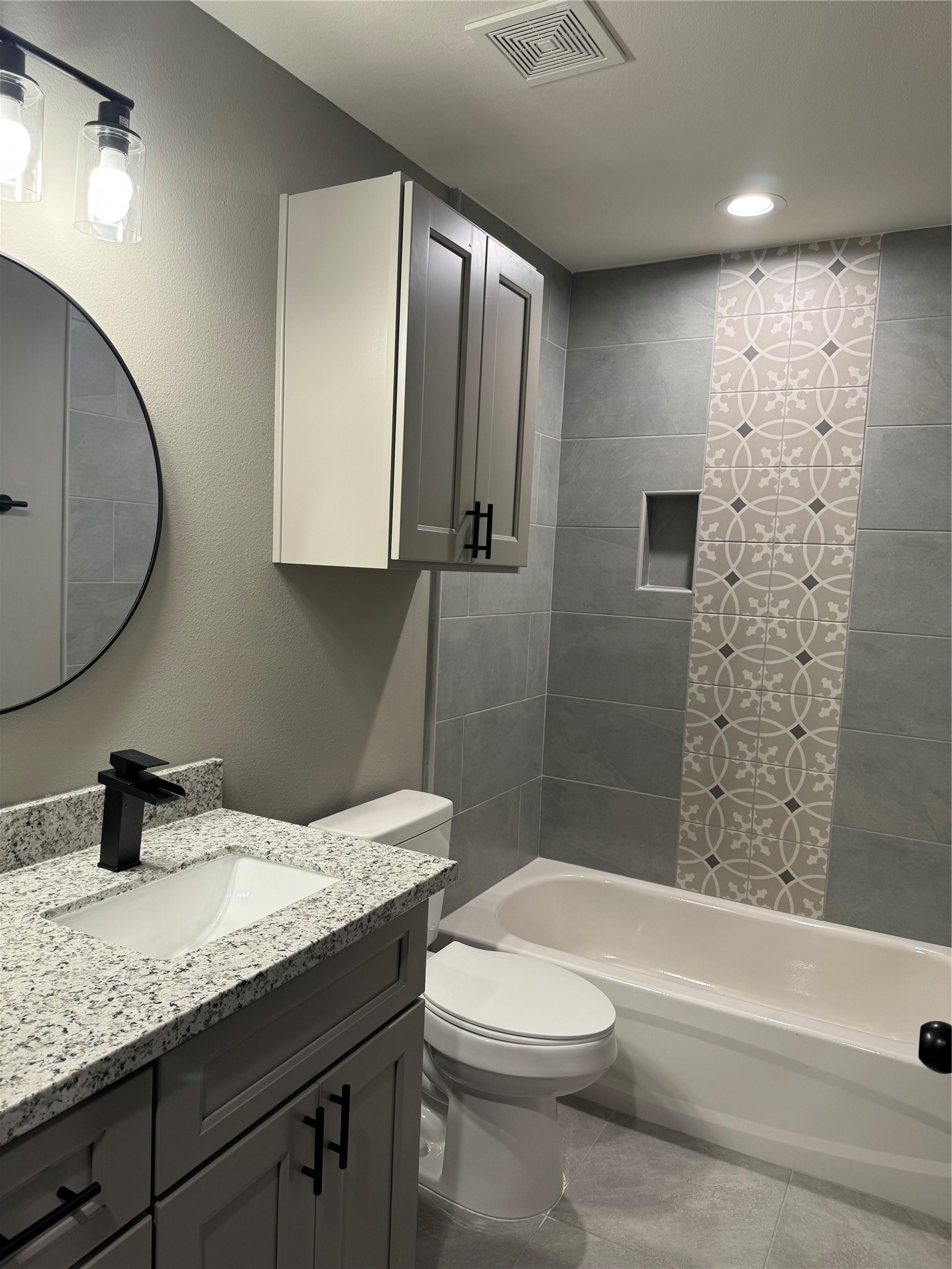 7906 Sexton Street Houston, TX 77028 - Photo 6 of 20 a bathroom with a granite countertop sink a toilet and shower