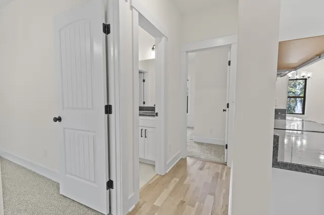 a view of a hallway with wooden floor