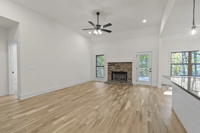 a view of empty room with wooden floor fireplace and windows