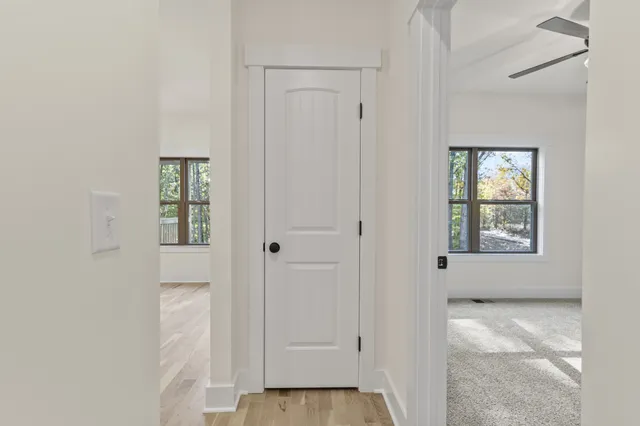 a view of an empty room with closet and a window