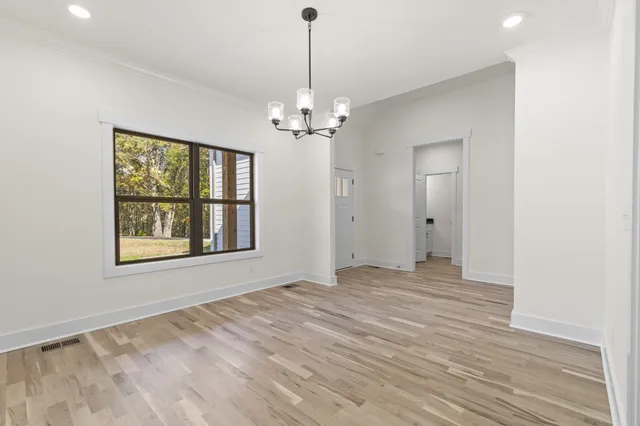 a view of a room with natural light and hardwood floor