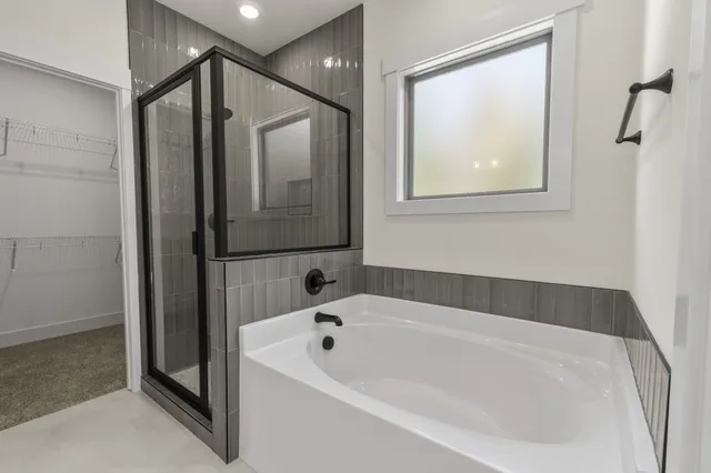 a bathroom with a tub a sink and mirrors
