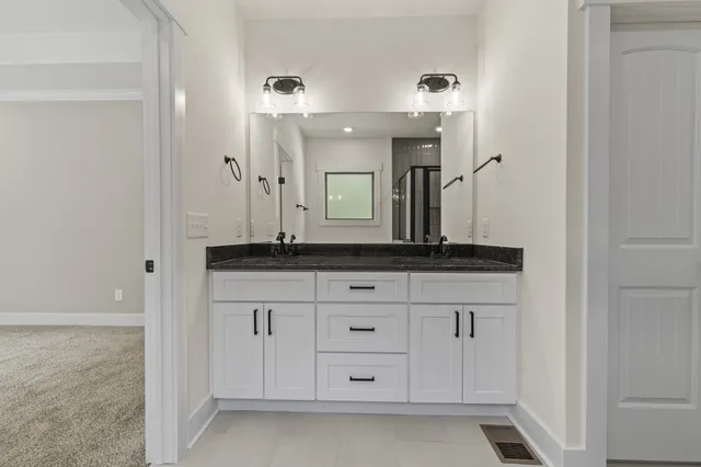 an empty room with a window and a ceiling fan