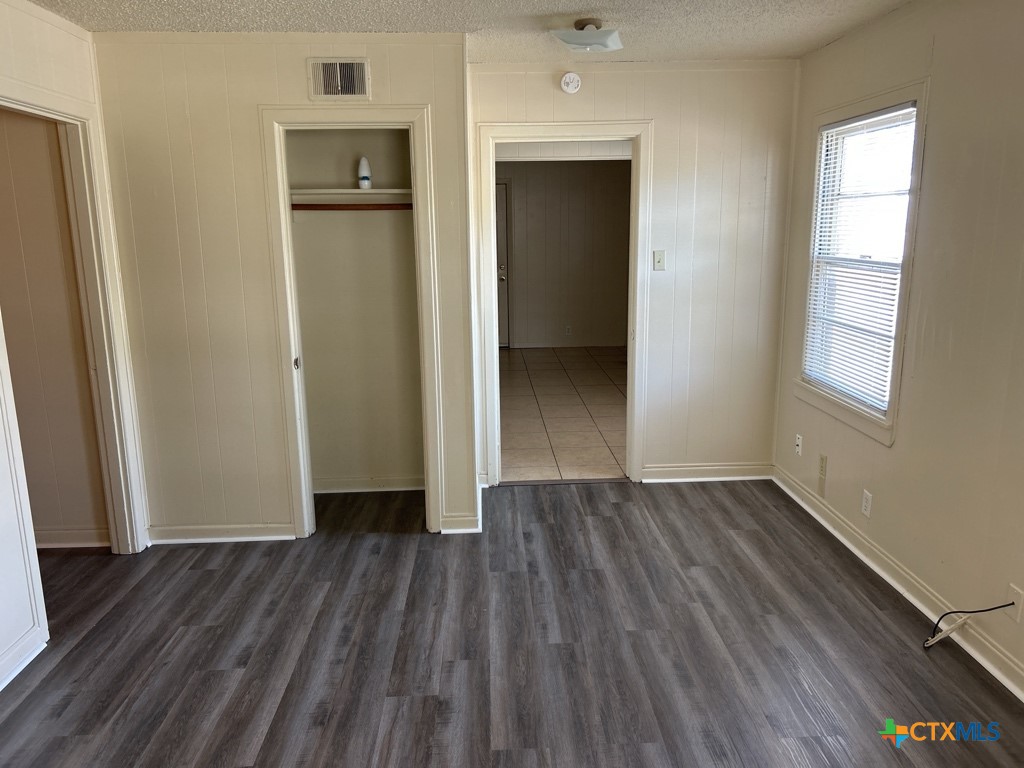 715 Cardinal Avenue Killeen, TX 76541 - Photo 3 of 12 an empty room with wooden floor and a window