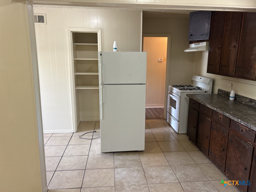 715 Cardinal Avenue Killeen, TX 76541 - Photo 5 of 12 a kitchen with a cabinets and a stove top oven