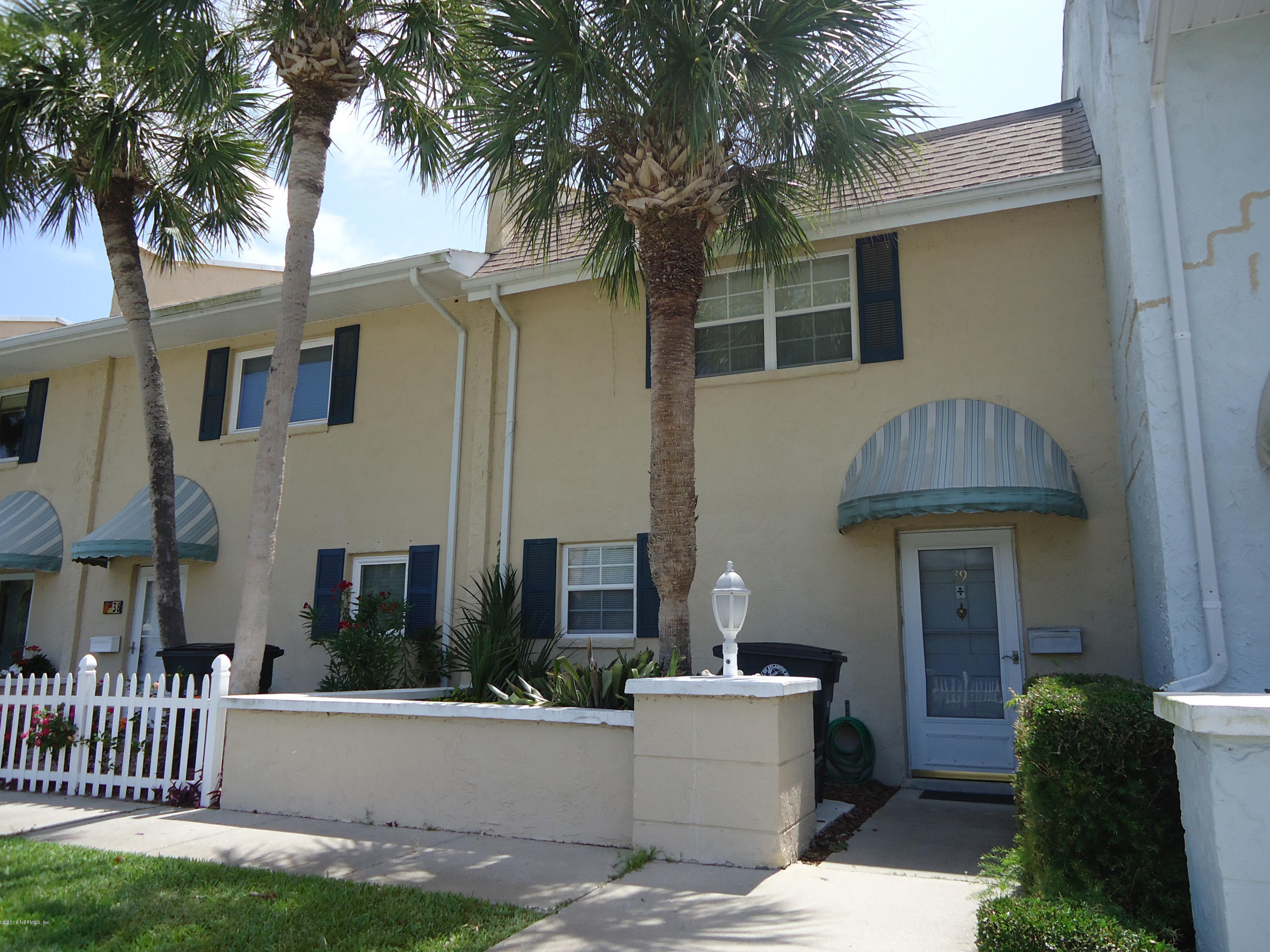 2233 Seminole Road, Unit 39 Atlantic Beach, FL 32233 - Photo 1 of 18 a front view of a house with a yard and garage