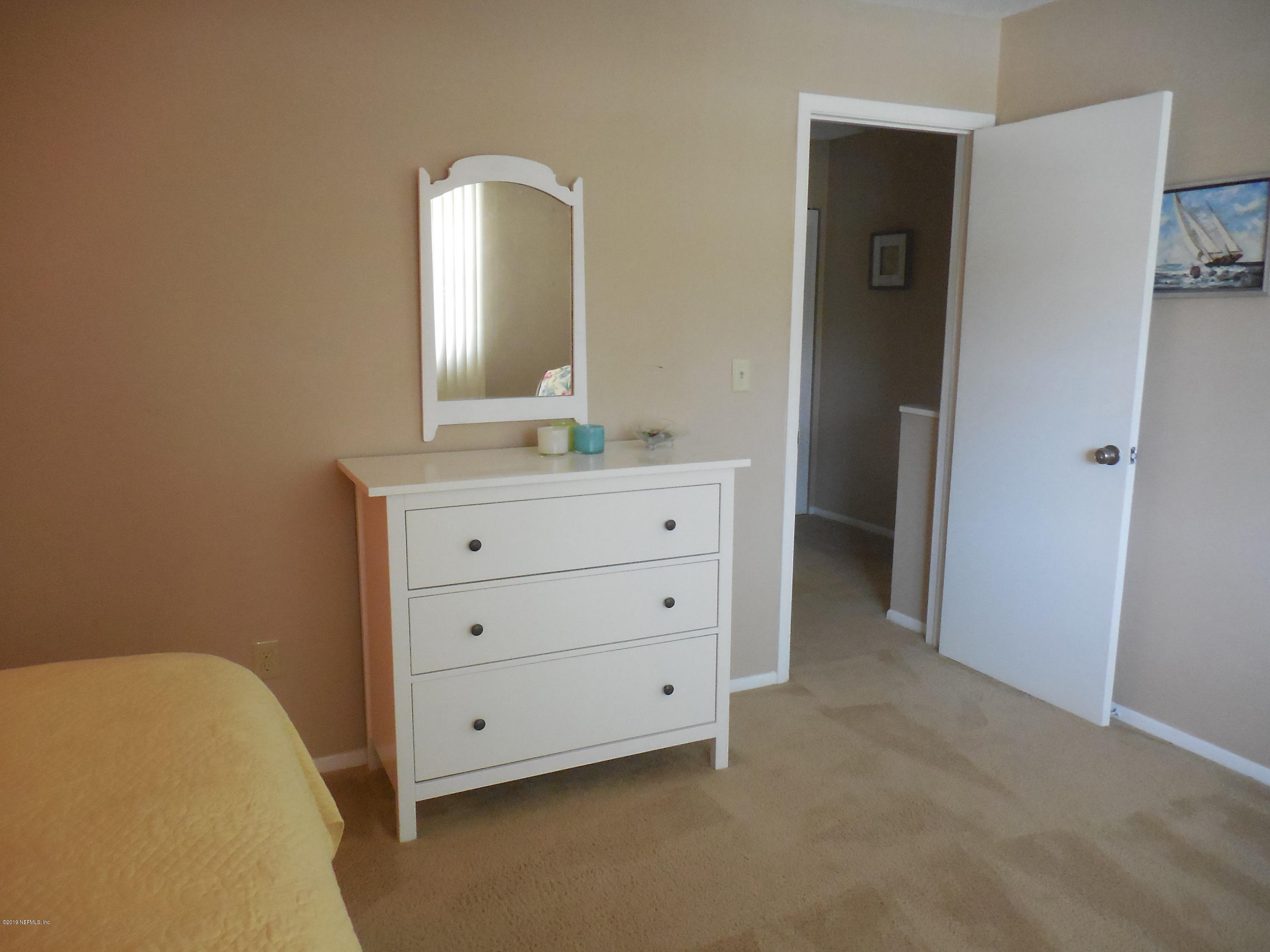 2233 Seminole Road, Unit 39 Atlantic Beach, FL 32233 - Photo 11 of 18 a bathroom with a granite countertop sink and a mirror