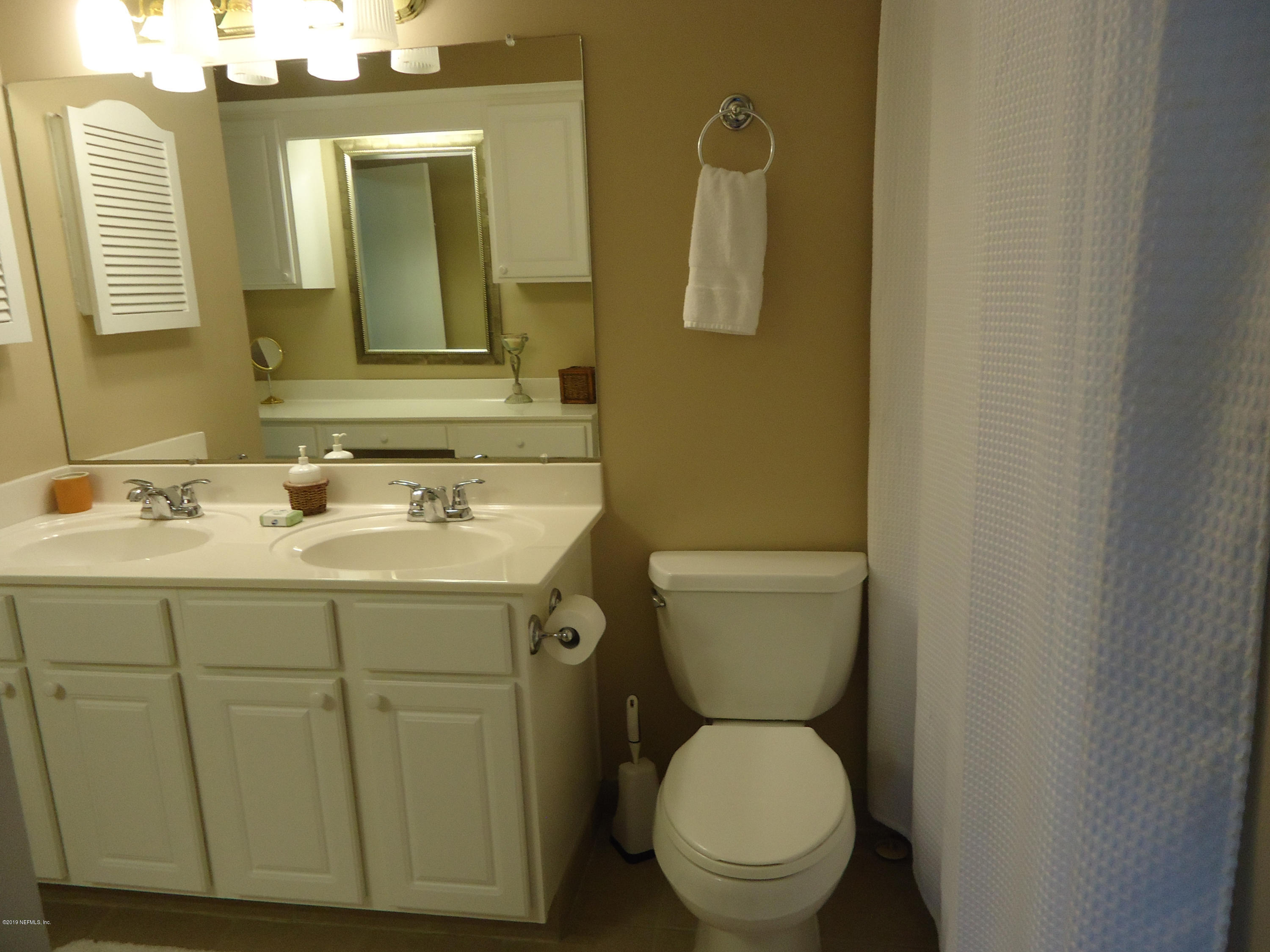 2233 Seminole Road, Unit 39 Atlantic Beach, FL 32233 - Photo 13 of 18 a bathroom with a toilet sink and mirror