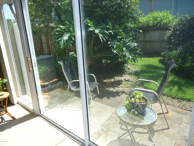 a vase of flowers sitting on a table with a garden