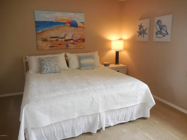 a bed room with a bed and a night stand