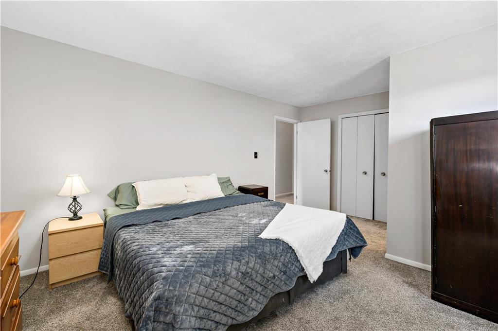 155 Brickyard Road Mars, PA 16046 - Photo 14 of 33 a spacious bedroom with a bed and a lamp