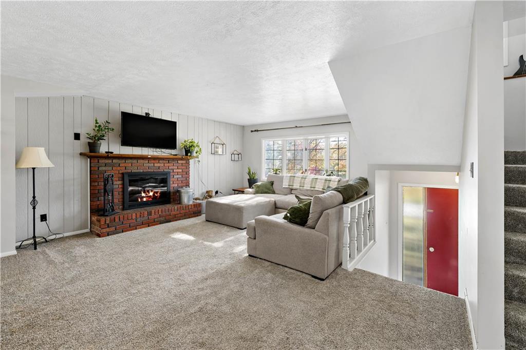 155 Brickyard Road Mars, PA 16046 - Photo 2 of 33 a living room with furniture a flat screen tv and a fireplace