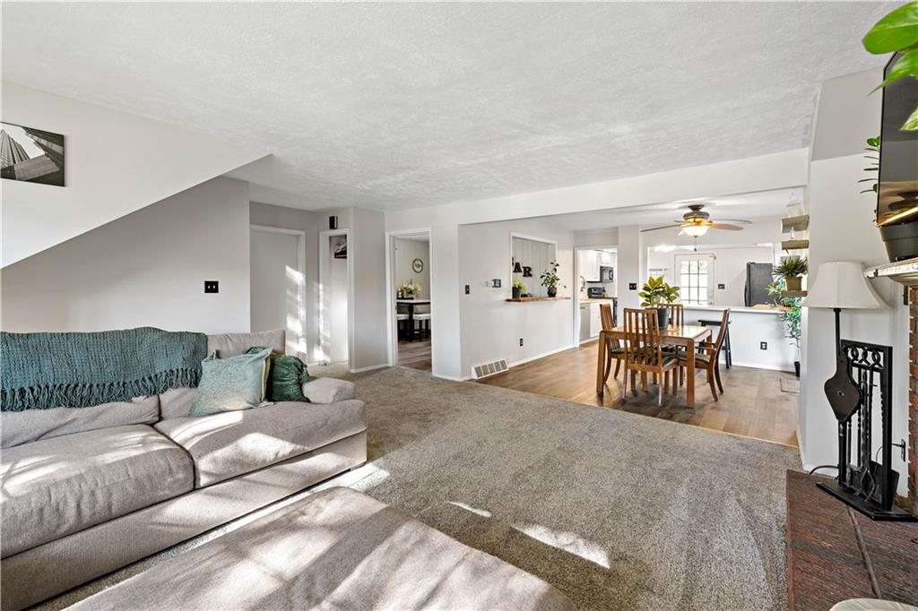 155 Brickyard Road Mars, PA 16046 - Photo 4 of 33 a living room with furniture and a dining table with kitchen view