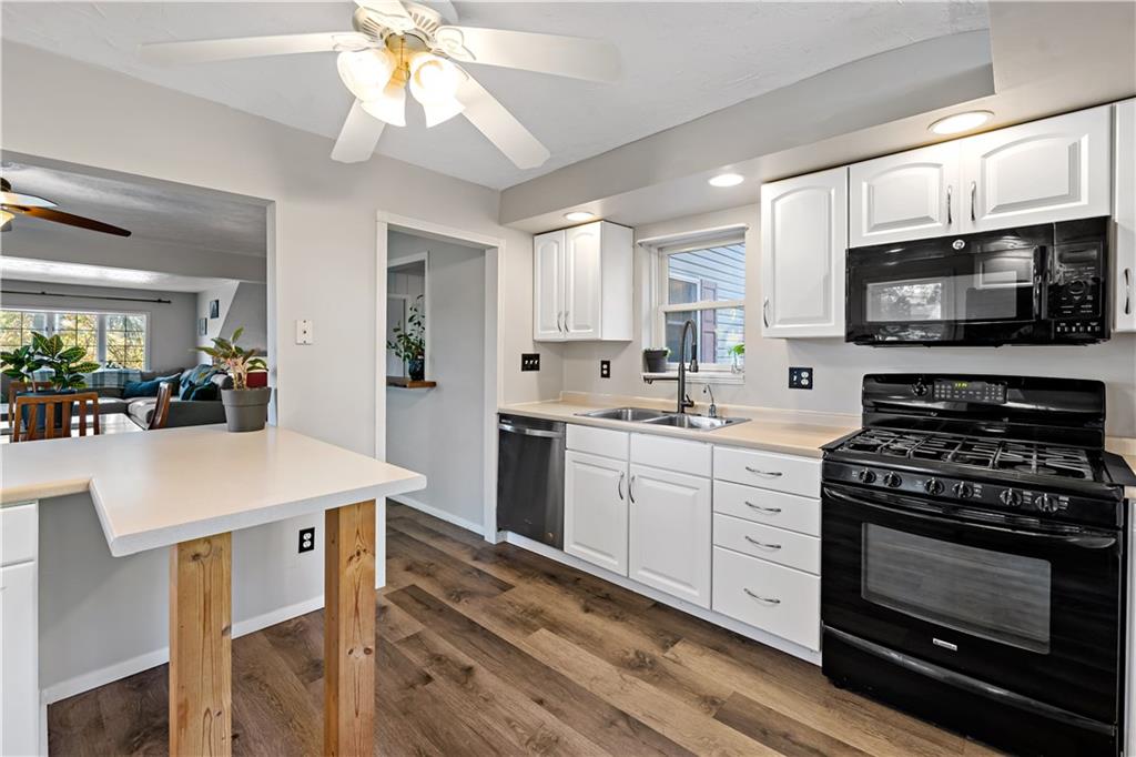 155 Brickyard Road Mars, PA 16046 - Photo 8 of 33 a kitchen with a stove a sink and a microwave