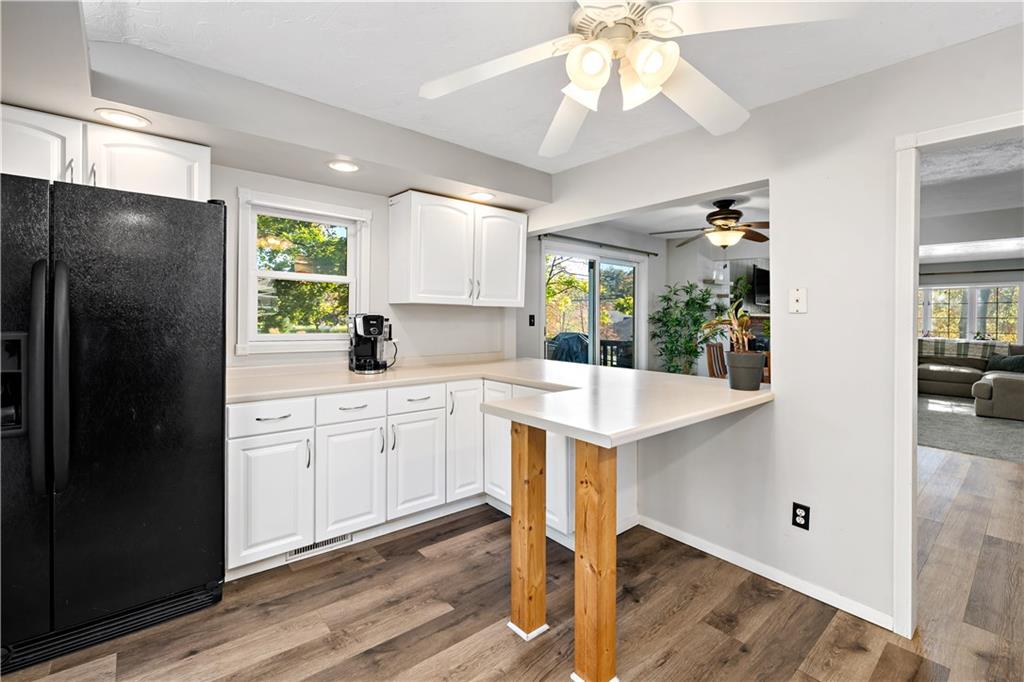 155 Brickyard Road Mars, PA 16046 - Photo 9 of 33 a kitchen with stainless steel appliances a refrigerator a sink dishwasher a stove and white cabinets with wooden floor