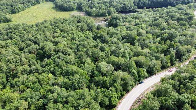 an aerial view of a house with a yard