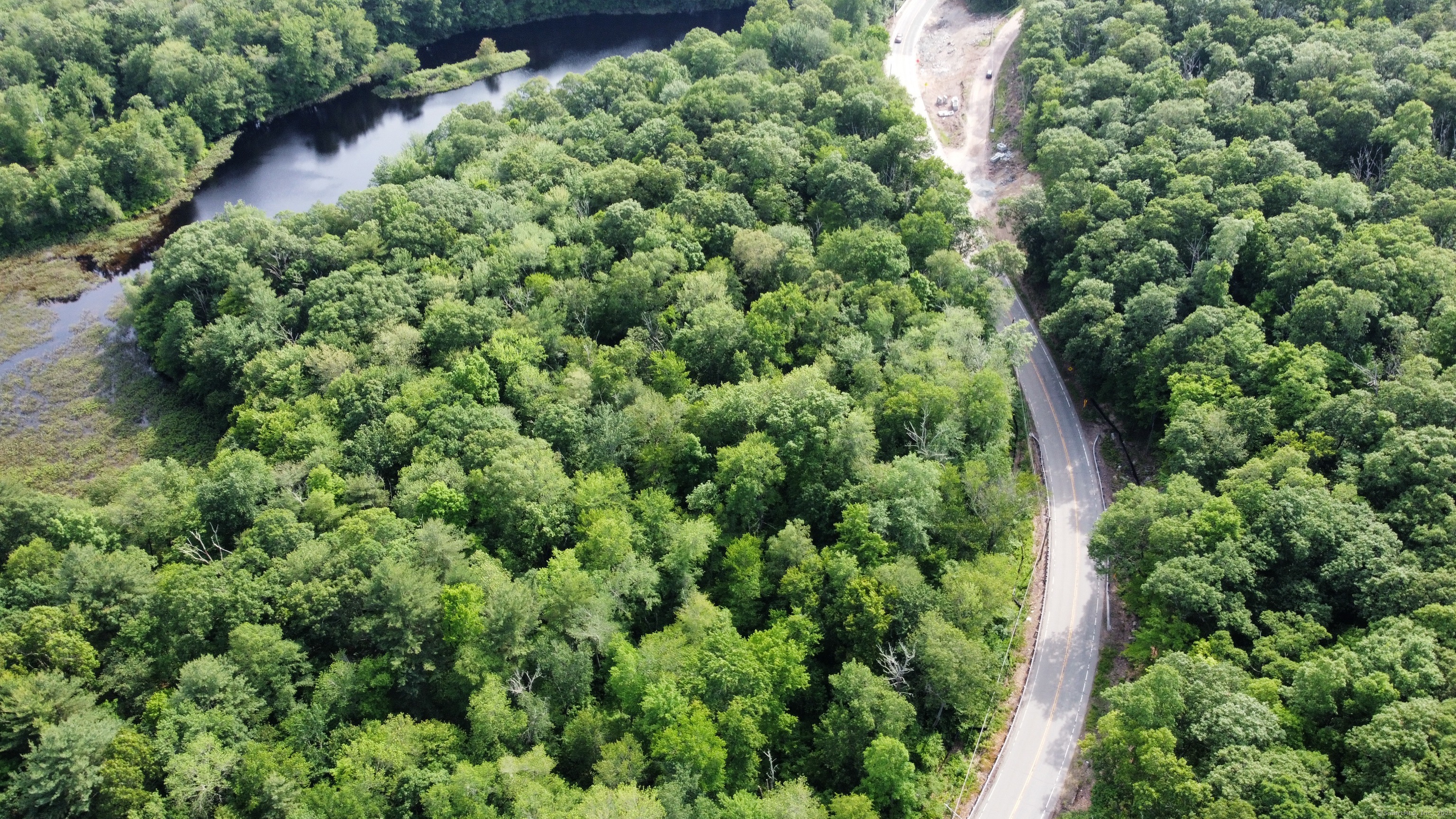 178 Crystal Lake Road Ellington, CT 06029 - Photo 8 of 27 an aerial view of a house with a lush green forest