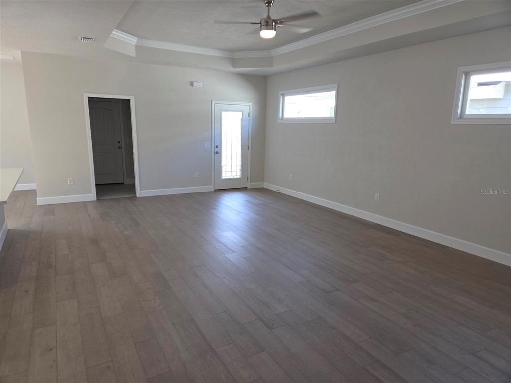 1761 Southwest 244th Way Newberry, FL 32669 - Photo 7 of 21 an empty room with wooden floor and windows