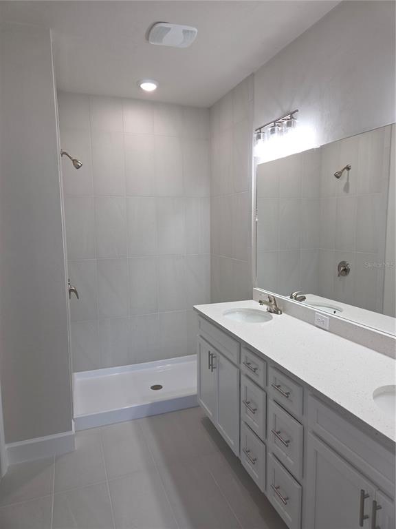 1761 Southwest 244th Way Newberry, FL 32669 - Photo 9 of 21 a bathroom with a double vanity sink and a mirror