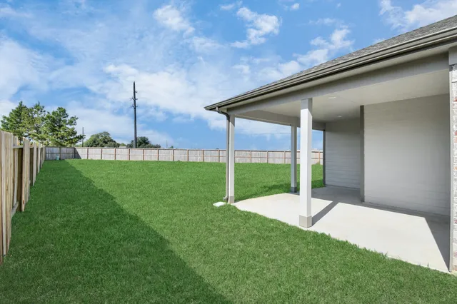 a view of a house with a big yard and large trees