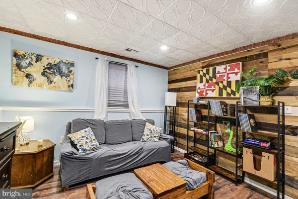 a living room with furniture a flat screen tv and a floor to ceiling window