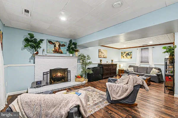 a bedroom with furniture a fireplace and a potted plant
