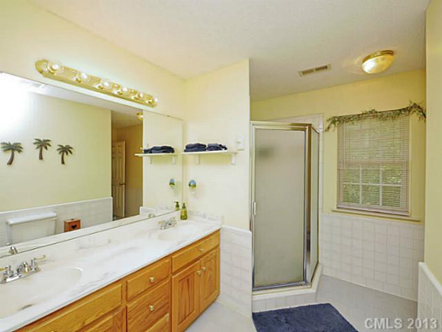 9922 Mini Ranch Road Waxhaw, NC 28173 - Photo 14 of 16 a bathroom with a double vanity sink mirror and shower